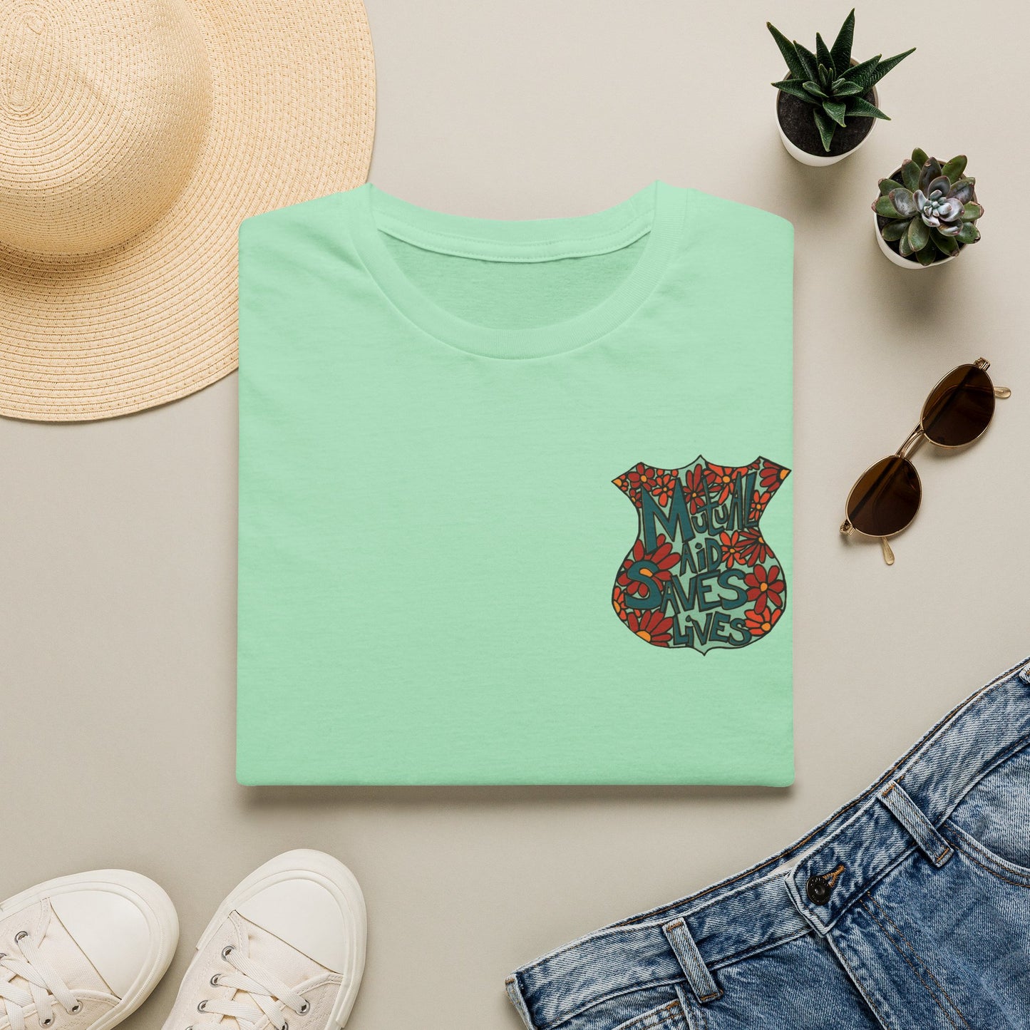 Vintage Floral Shield T‑Shirt — 'Mutual Aid Saves Lives' Pocket Graphic
