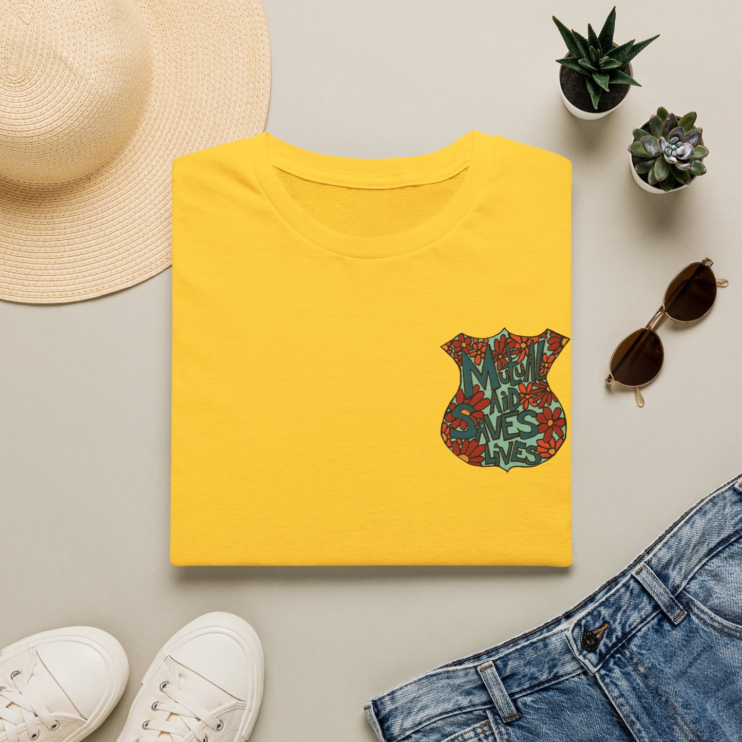 Vintage Floral Shield T‑Shirt — 'Mutual Aid Saves Lives' Pocket Graphic
