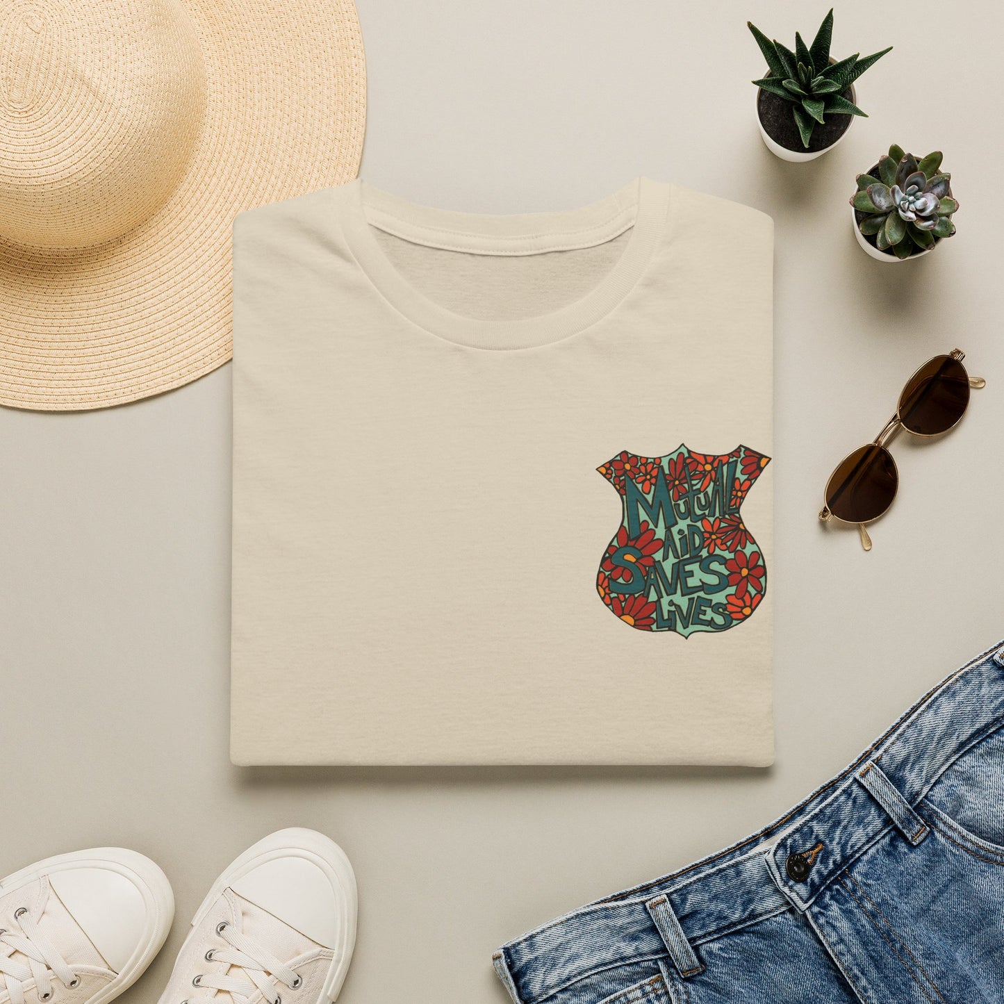 Vintage Floral Shield T‑Shirt — 'Mutual Aid Saves Lives' Pocket Graphic