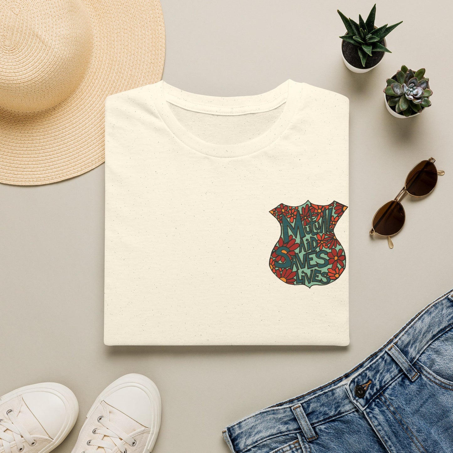 Vintage Floral Shield T‑Shirt — 'Mutual Aid Saves Lives' Pocket Graphic