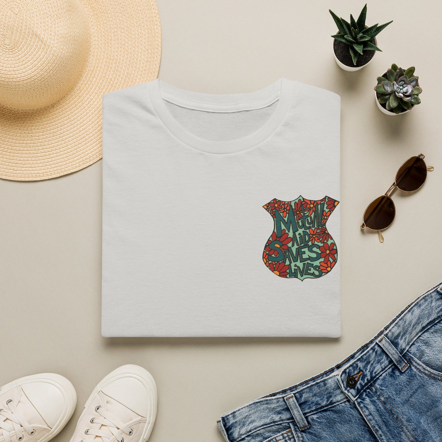 Vintage Floral Shield T‑Shirt — 'Mutual Aid Saves Lives' Pocket Graphic