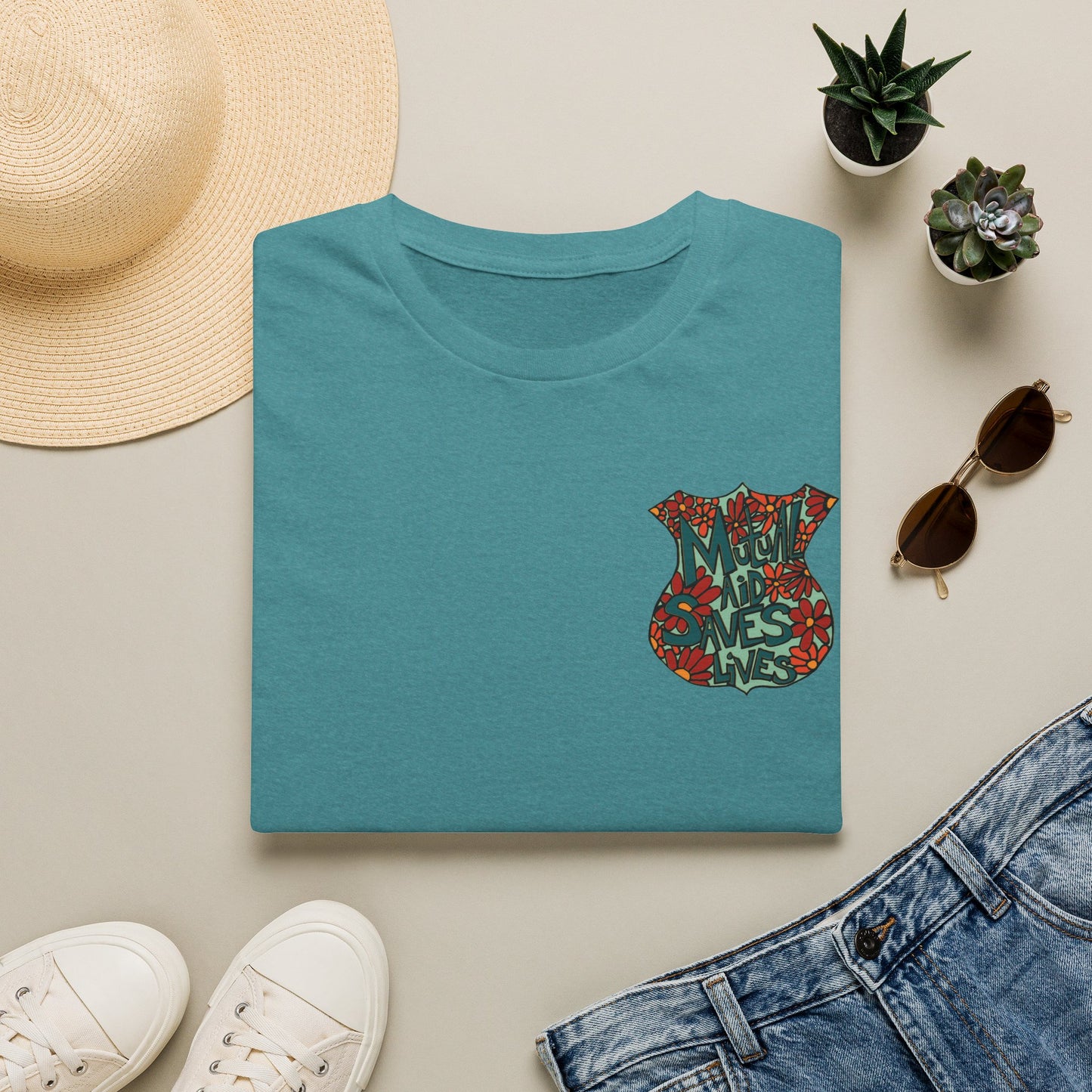 Vintage Floral Shield T‑Shirt — 'Mutual Aid Saves Lives' Pocket Graphic