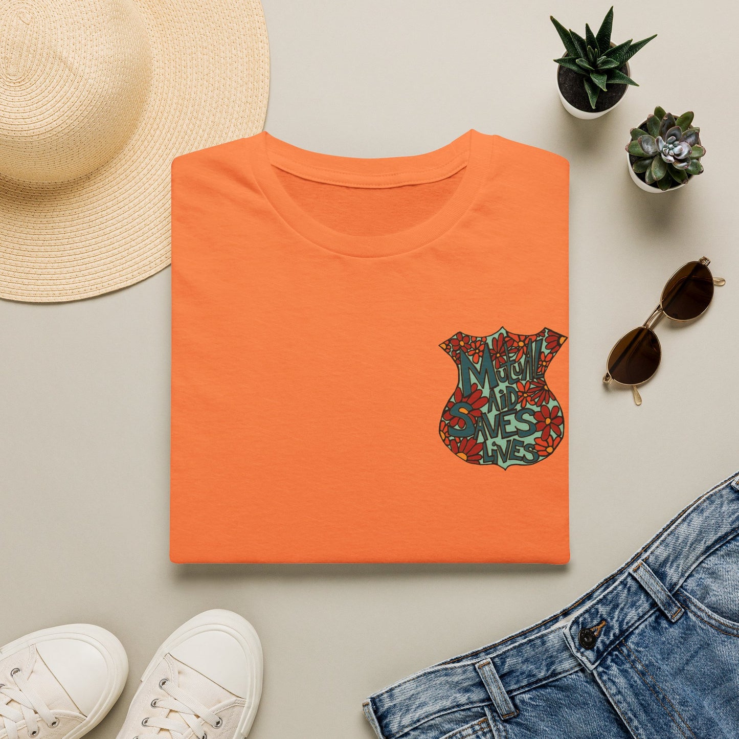 Vintage Floral Shield T‑Shirt — 'Mutual Aid Saves Lives' Pocket Graphic